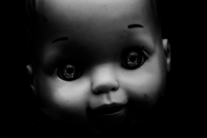 Close crop portrait of a doll with mesmerising, shining eyes