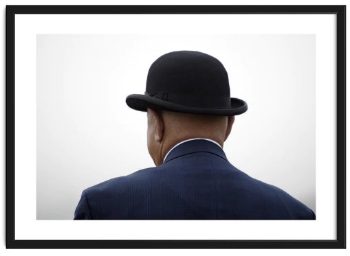 Framed candid image of an elderly man in a bowler hat photographed from behind